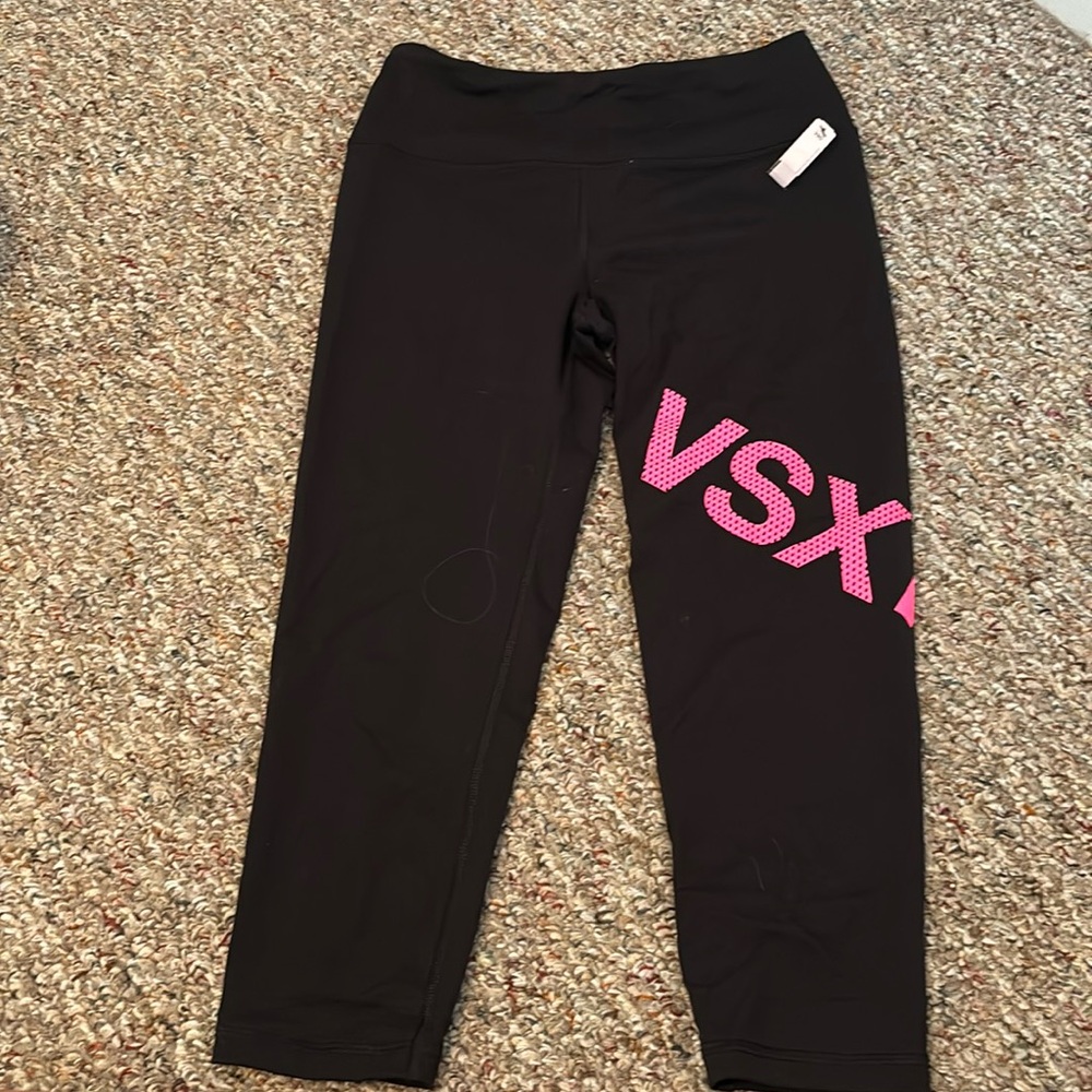 Black with pink logo Victoria Secret carpi leggings.